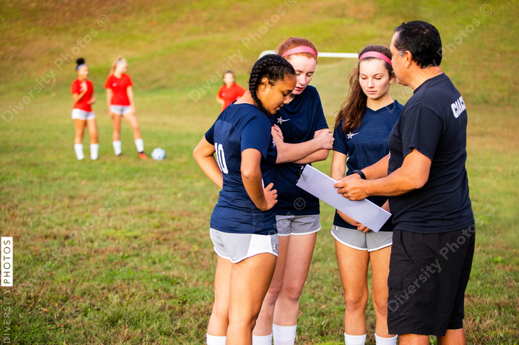 Man coaching girls soccer team