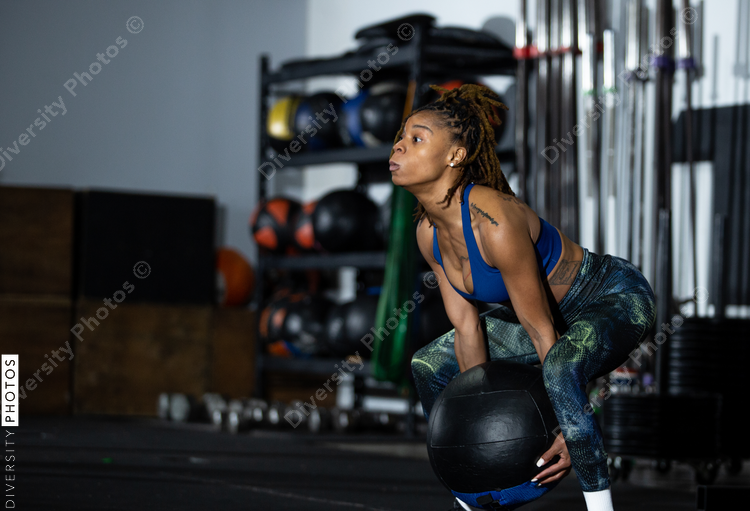 African American woman exercising in gym, health and fitness