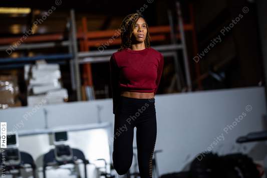Black fit woman stretching and doing exercises at gym