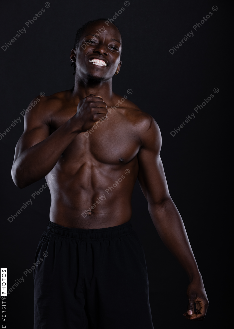 Fit African American man with muscles posing in studio