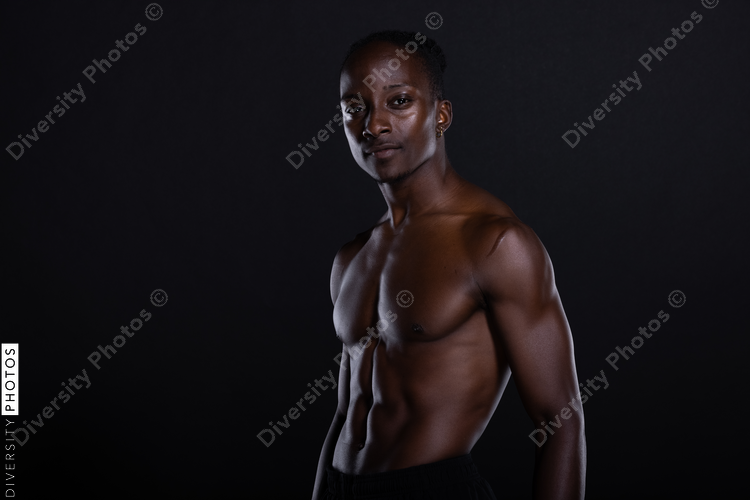 Fit African American man with muscles posing in studio