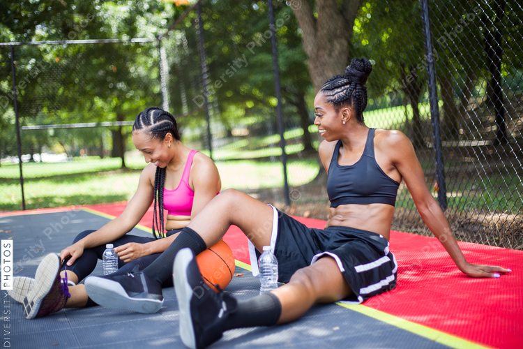 Women relaxing while playing basketball