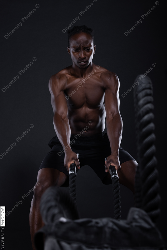 African American man doing intense sports training, exercises 