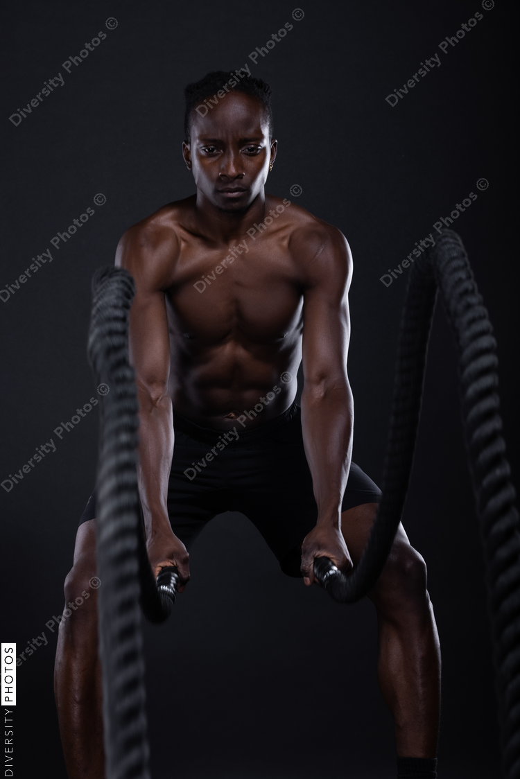 African American man doing intense sports training, exercises 