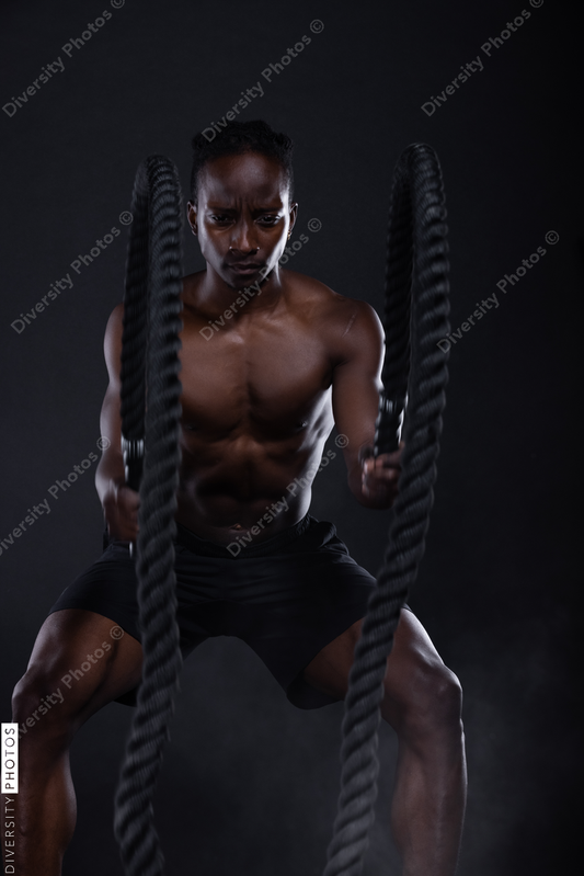 African American man doing intense sports training, exercises 