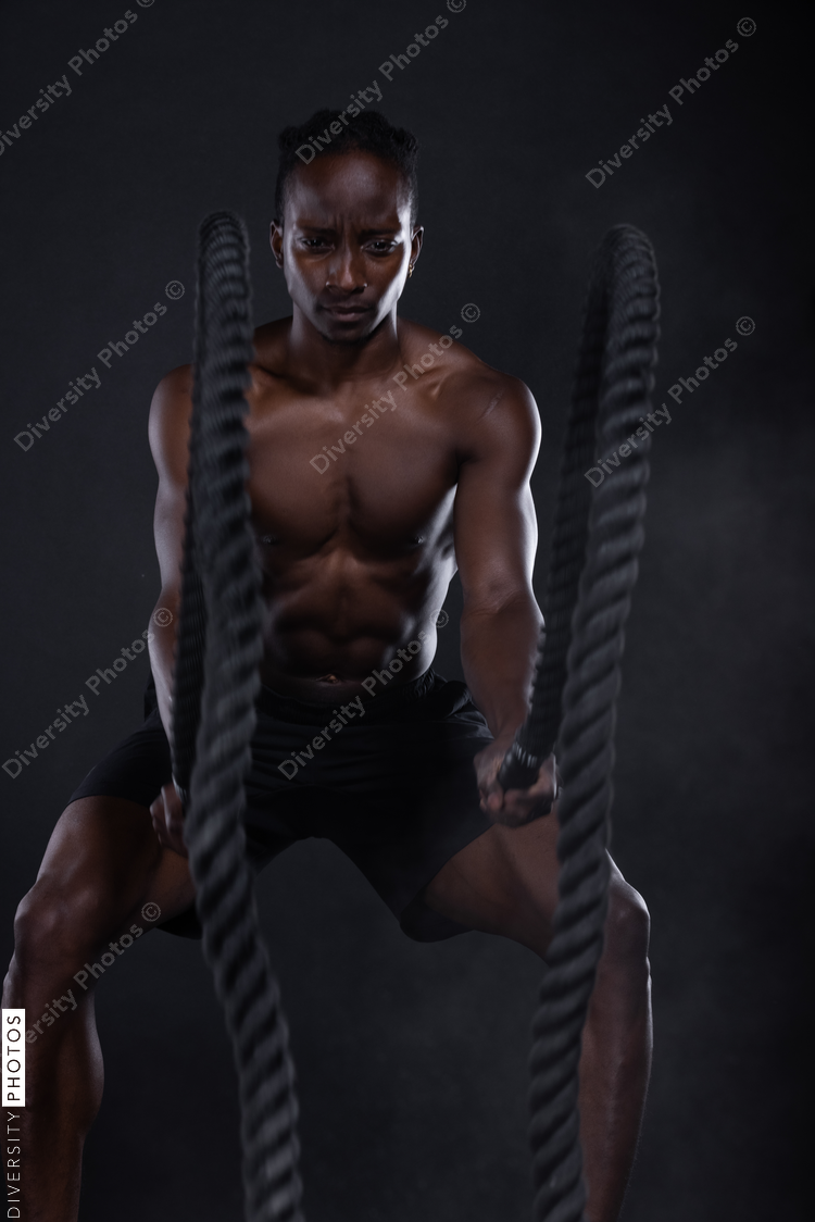 African American man doing intense sports training, exercises 