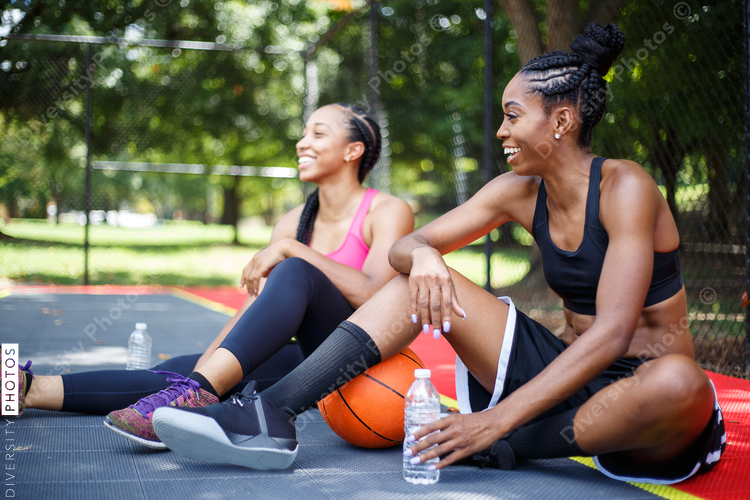 Women laughing on basketball court