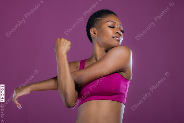 African American woman stretches her arms before workout exercise 