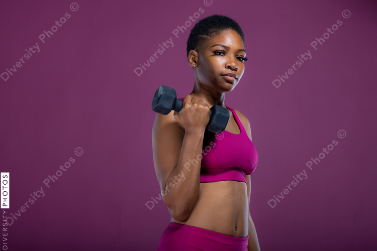 Black woman doing workout with dumbbells 
