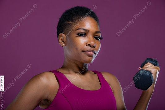 Black woman doing workout with dumbbells 