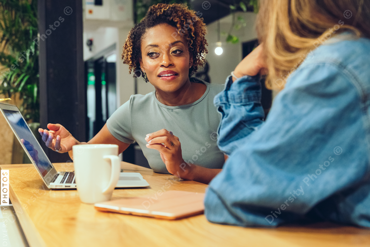 Businesswomen talking with each other in office