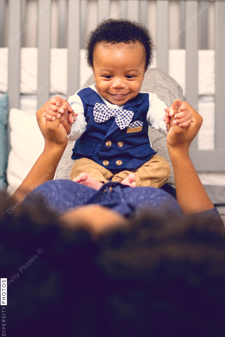 Smiling son playing with his mother at home