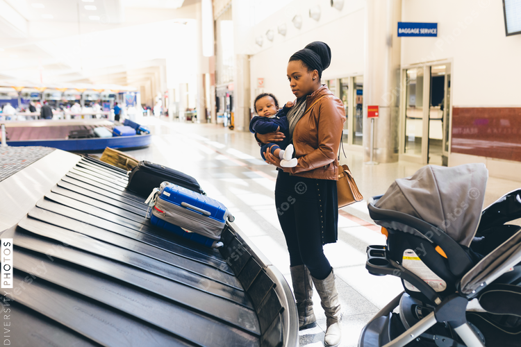 Woman with her son standing near baggage carousel at airport