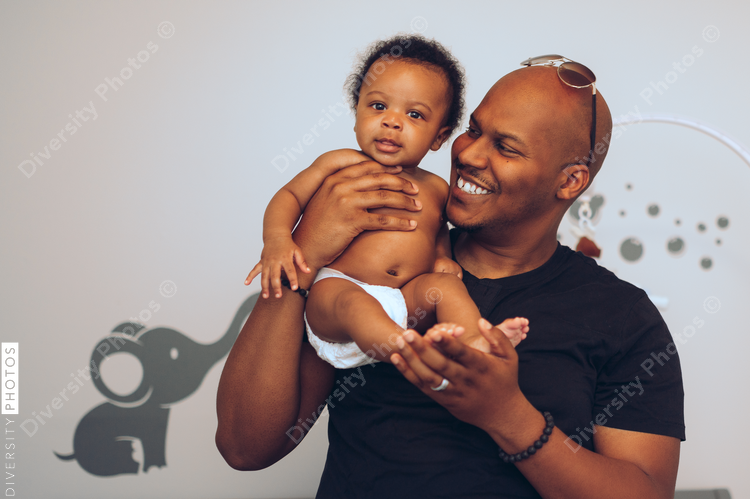Father holds smiling baby son