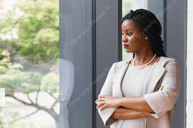 Profile of businesswoman looking out window
