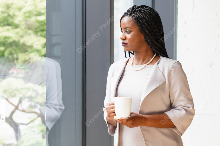 Profile of businesswoman holding coffee mug