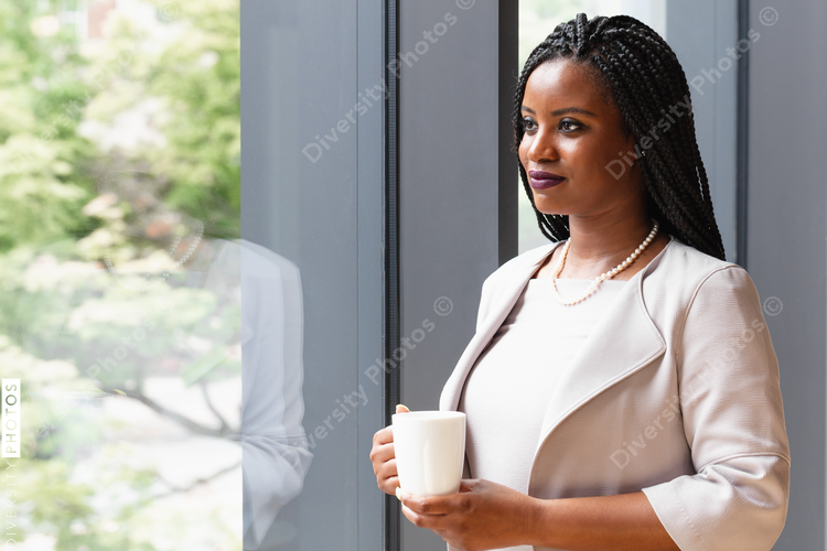 Profile of businesswoman holding coffee mug