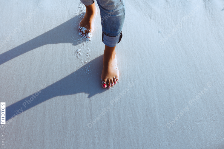Black woman walking along the beach