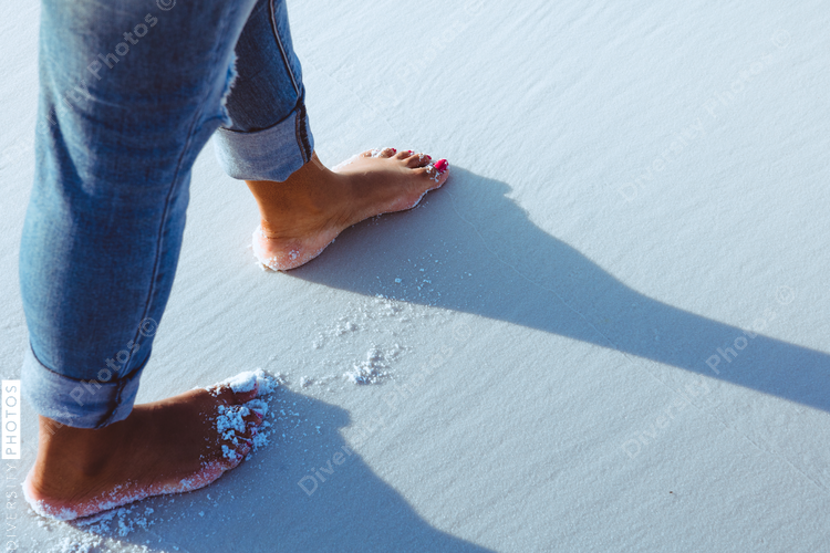 Black woman walking along the beach
