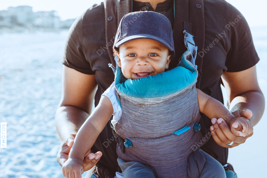 Black father and son walking on the beach
