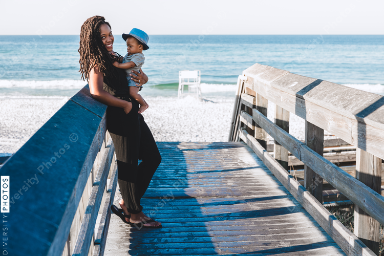 Black mom and son on boardwalk
