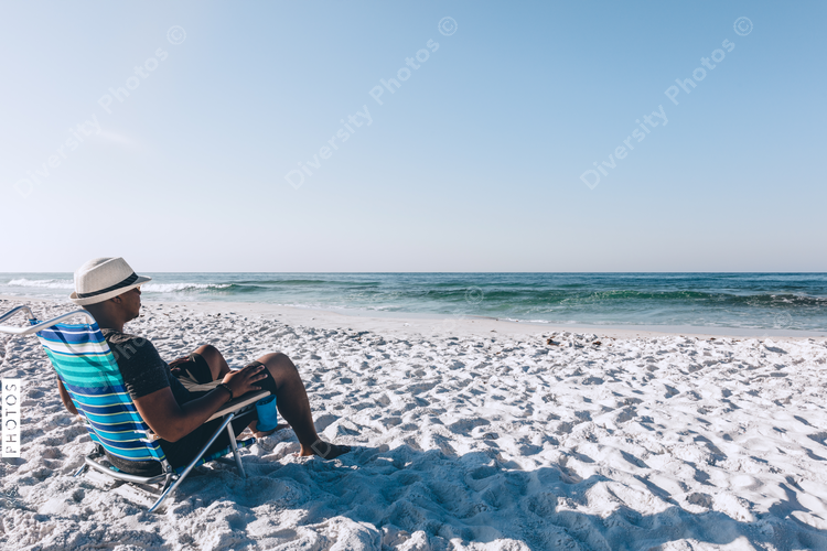 Black man relaxing on the beach