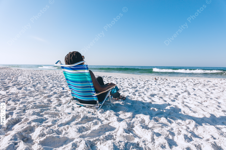 Black woman relaxing on the beach
