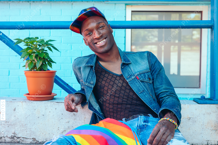 Portrait of young man in jean jacket and mesh shirt
