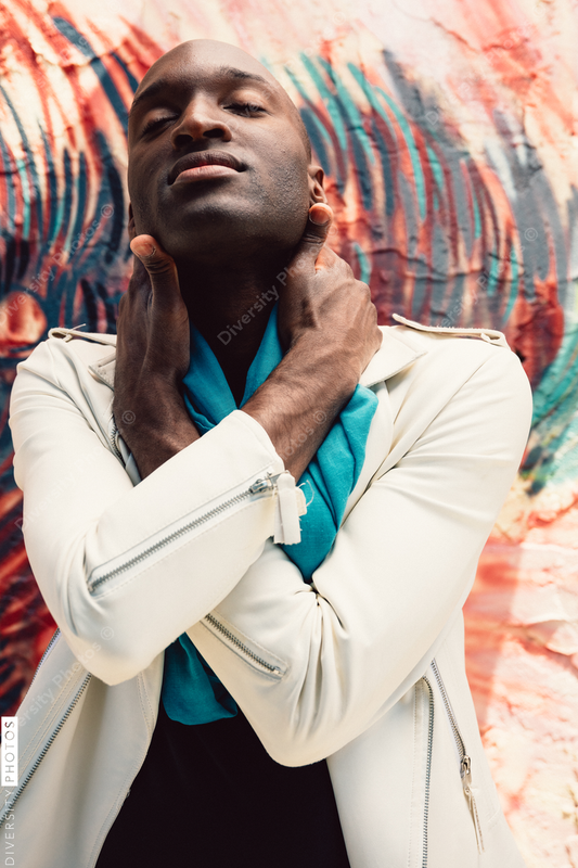 Young man wraps hands around his neck