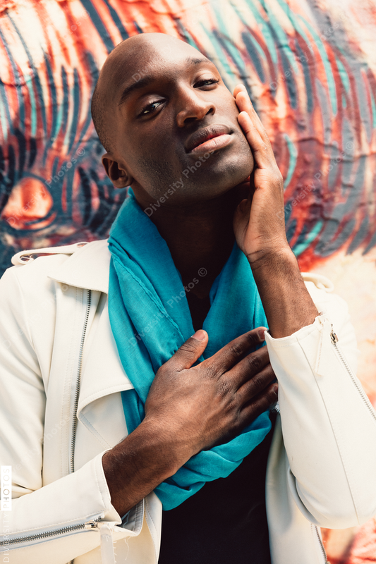 Young man touches hand to his face