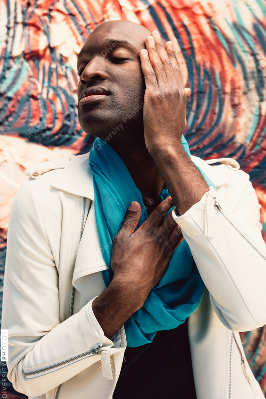 Young man with eyes closed and hand over ear
