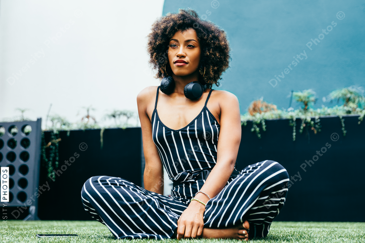 Low angle view of woman sitting cross-legged on grass