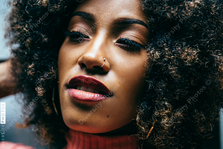 Close up portrait of woman with natural hair and nose ring