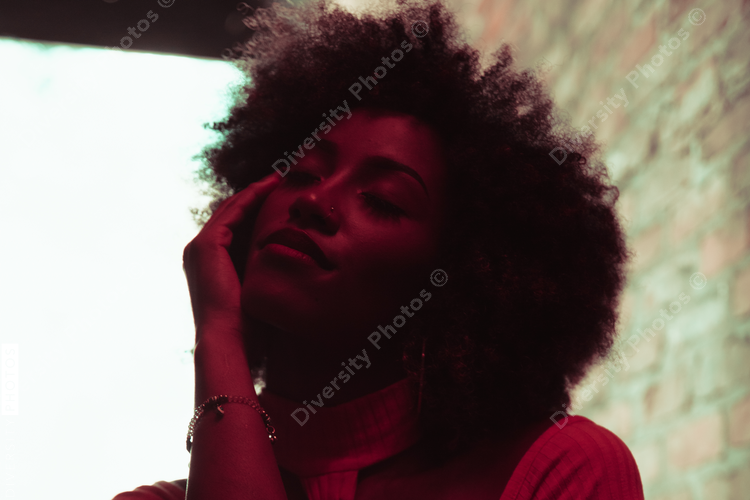 Backlit portrait of woman with natural hair