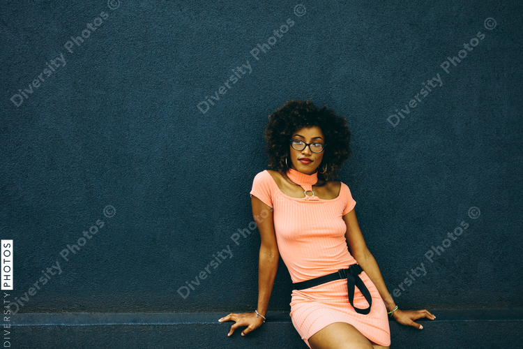 Portrait of woman with natural hair and pink summer dress