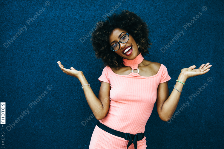 Smiling woman poses with palms up