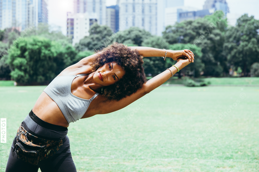 Young woman exercising in city park
