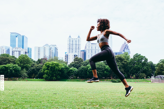 Young woman exercising in city park