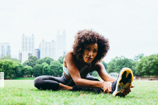 Young woman exercising in city park