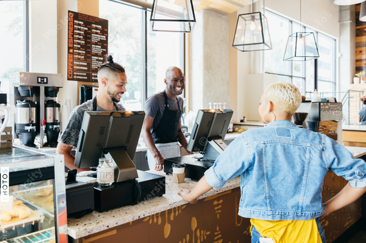 Barista serving customer at cafe