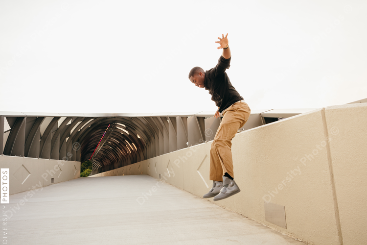 Man jumping on bridge