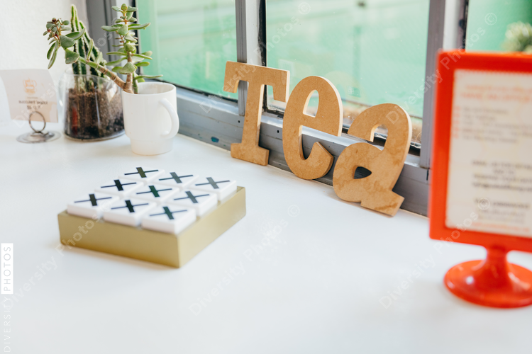 Lettering of tea placed on floor in cafe