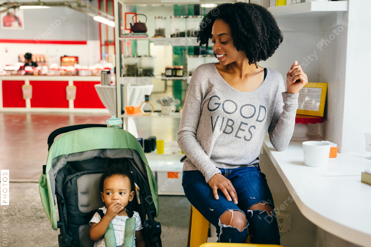 Woman smiling at boy in stroller