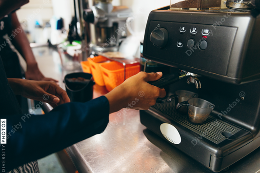 Barista fixing coffee order to customer