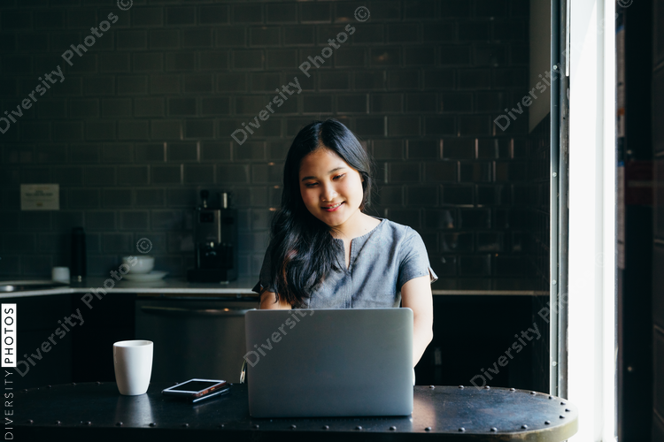 Woman smiling while watching laptop