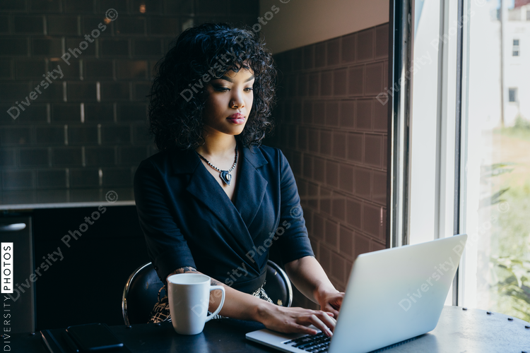 Close up view of woman working on laptop