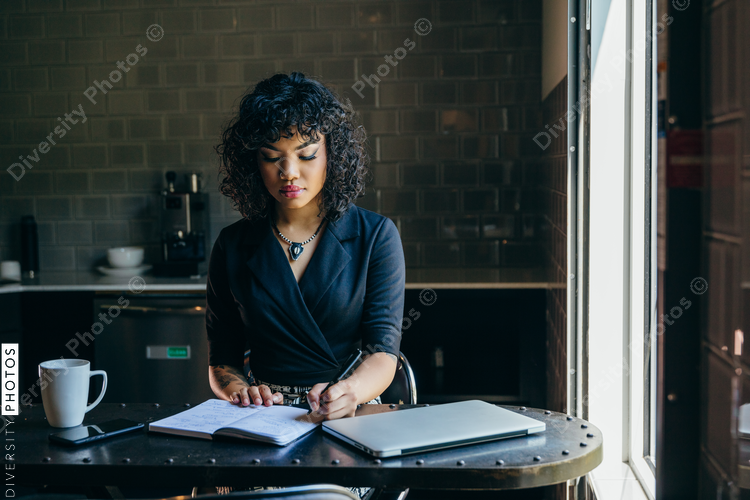 Woman writing at her desk