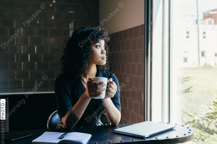 Woman holding coffee cup in office
