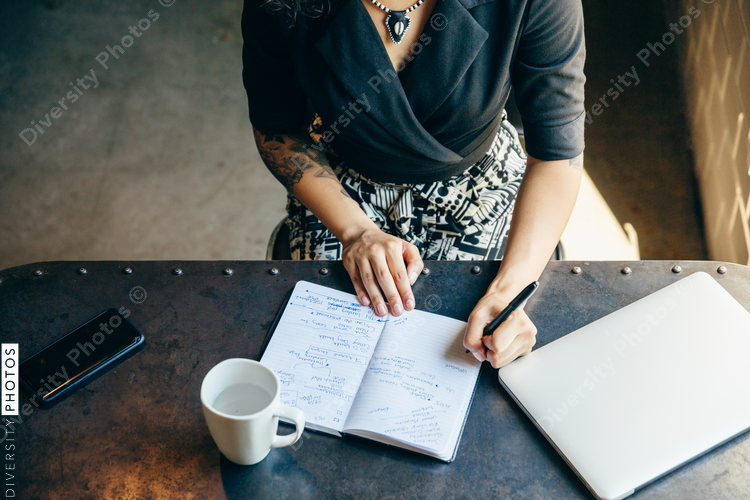 Directly above view of  young businesswoman writing notes