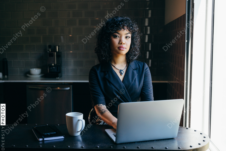 Close up view of young woman working in modern office cafeteria
